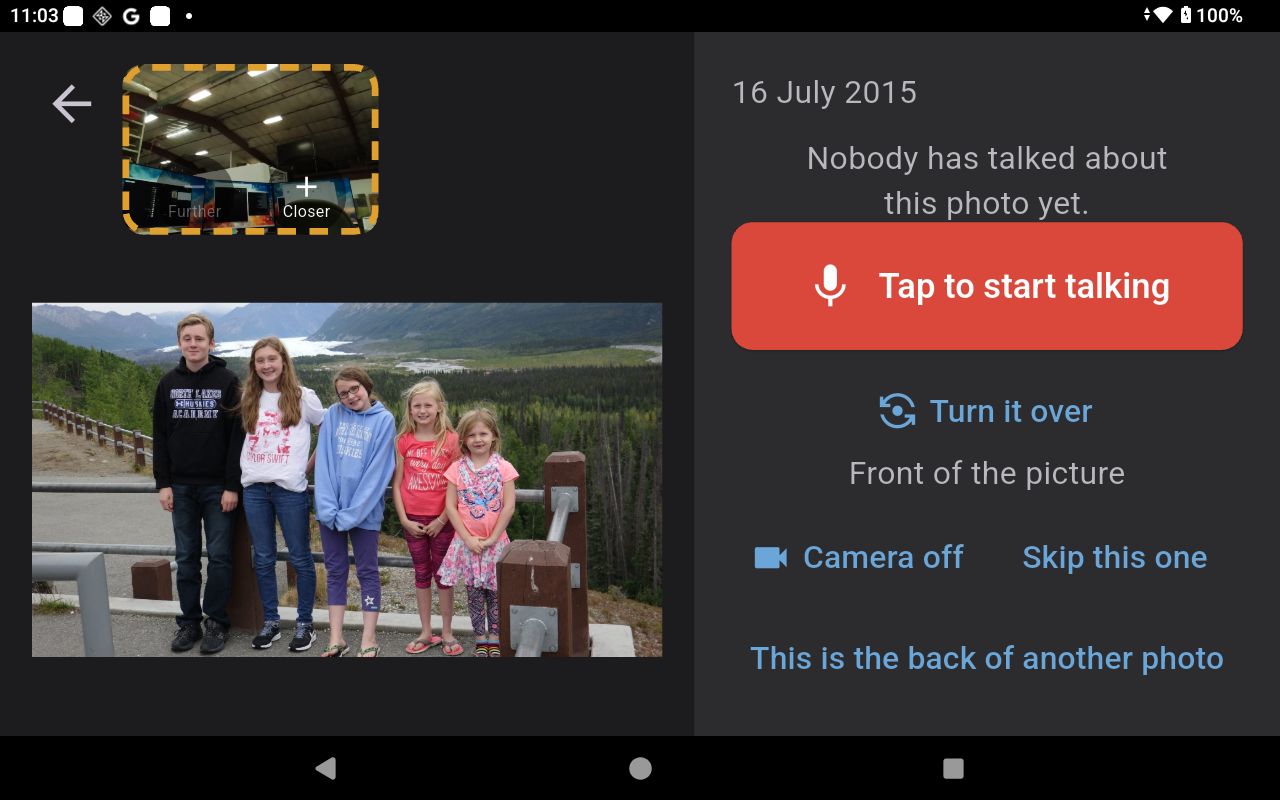 A photo filling most of the screen, with a small live camera view in the corner and a large red Tap to start talking button beside it.