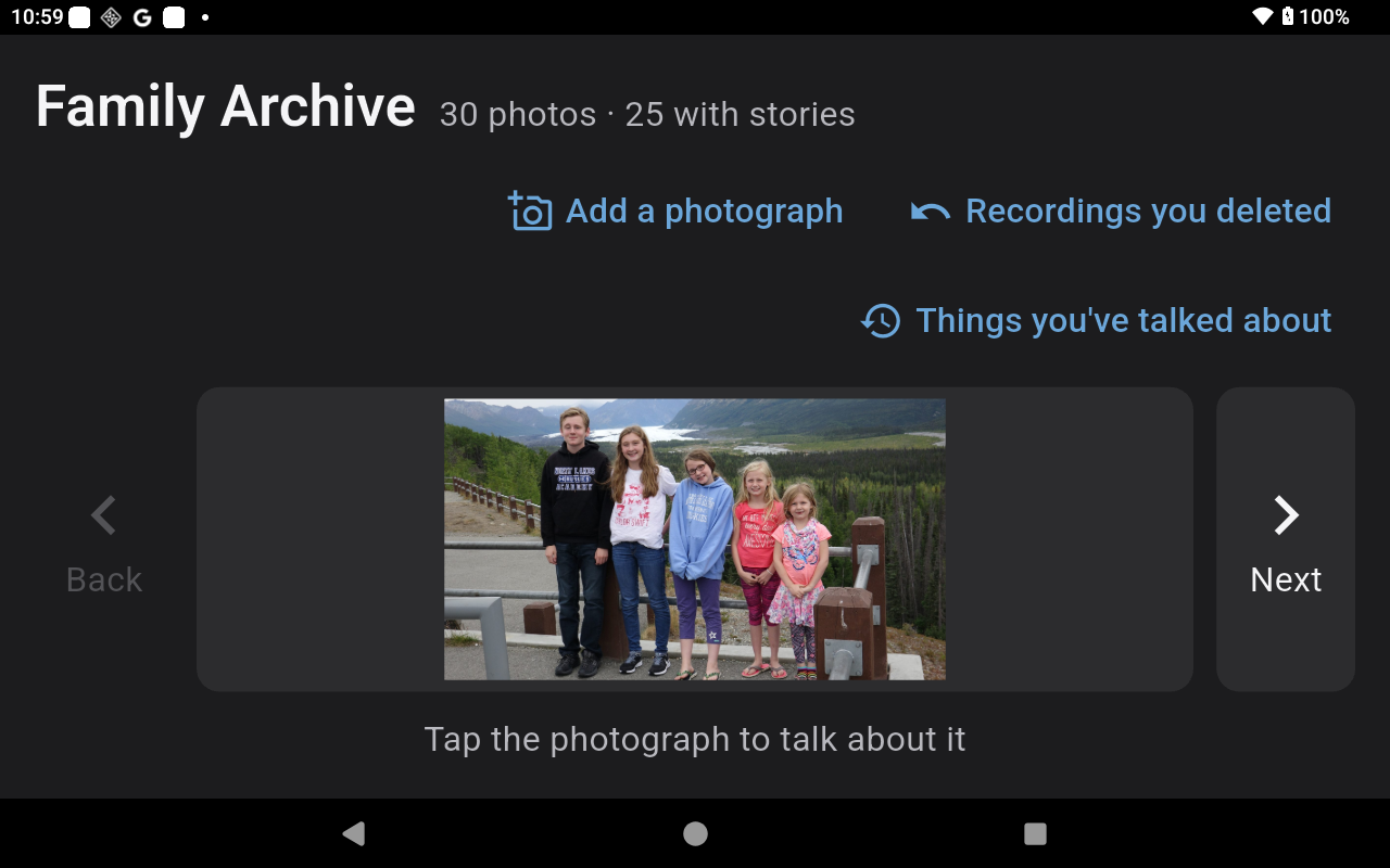 The app's main screen: the family archive name, a large photo, and Back and Next arrows either side of it.